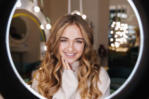 young girl with holiday glow looking in mirror