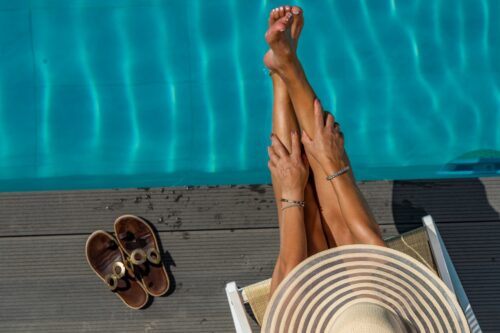 woman sitting by the swimming pool